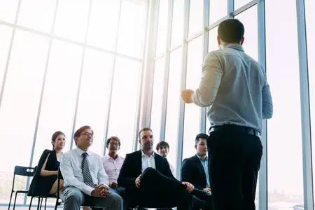 Person giving presentation to a full room